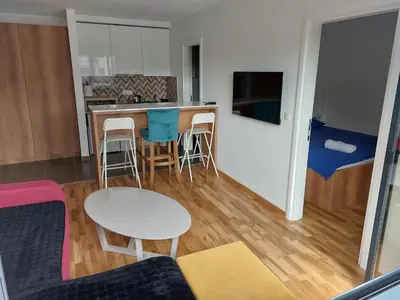 a kitchen and living room with a table and chairs at Centar Crnjanski in Jagodina