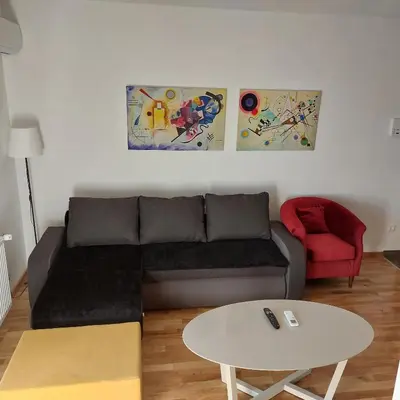 a living room with a couch and a table at Centar Crnjanski in Jagodina