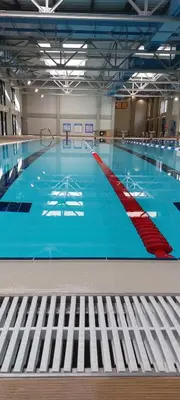 a large swimming pool with a blue floor at Centar Crnjanski in Jagodina