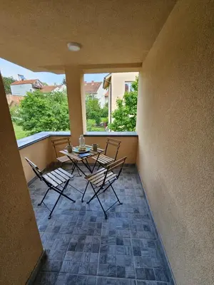 a patio with a table and chairs on a balcony at Apartmani Bambi 2 in Soko Banja