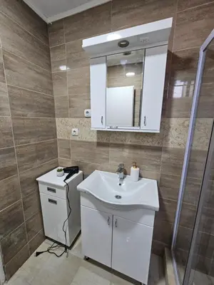 a bathroom with a white sink and a mirror at Apartmani Bambi 2 in Soko Banja
