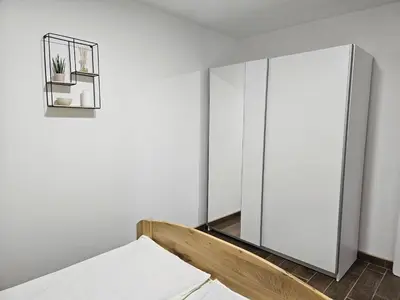 a bedroom with a mirror and a bed at Apartmani Bambi 2 in Soko Banja