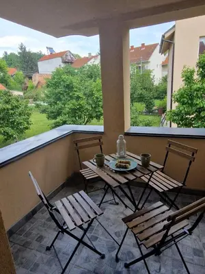 a patio with a table and chairs on a balcony at Apartmani Bambi 2 in Soko Banja