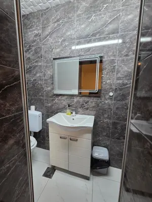 a bathroom with a sink and a mirror at Apartmani relax in Leskovac