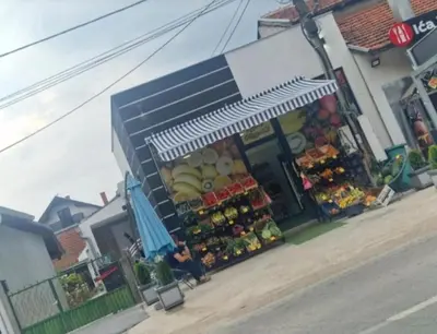 a store with a fruit stand on the side of a street at Apartmani relax in Leskovac