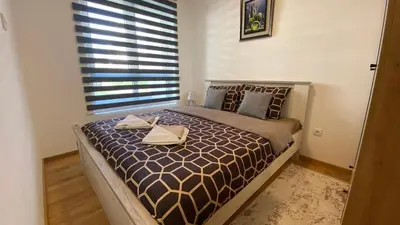 a bedroom with a bed with two towels on it at Apartman Ružica Sokobanja in Soko Banja