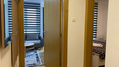 a room with a door leading to a living room at Apartman Ružica Sokobanja in Soko Banja