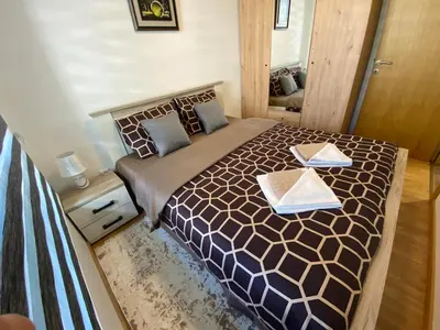 a bedroom with a large bed with two trays on it at Apartman Ružica Sokobanja in Soko Banja