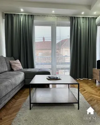 a living room with a couch and a coffee table at House Inn in Pirot
