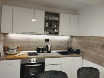 a kitchen with white cabinets and a stove top oven at MAFI AS APARTMAN in Soko Banja