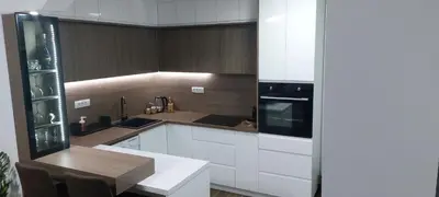 a kitchen with white cabinets and a black appliance at MAFI AS APARTMAN in Soko Banja