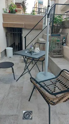 a patio with a table and chairs on a balcony at MAFI AS APARTMAN in Soko Banja