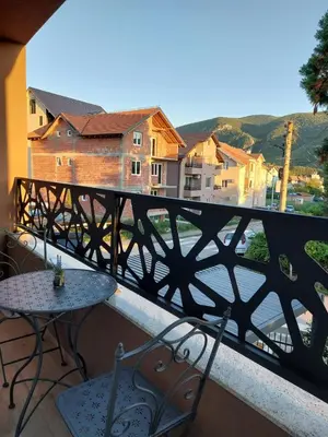 a balcony with a table and chairs and a view at MAFI AS APARTMAN in Soko Banja