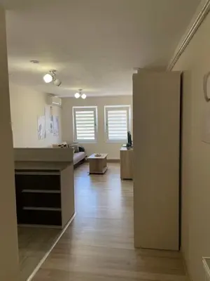 an empty room with a living room and a room with at Apartmani Vrla in Vladičin Han