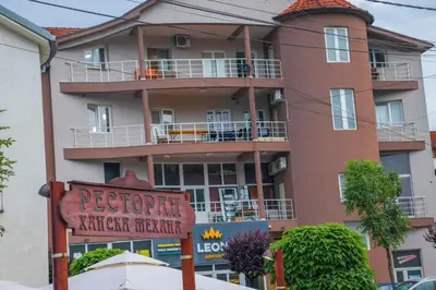 a large building with a sign in front of it at Apartmani Vrla in Vladičin Han