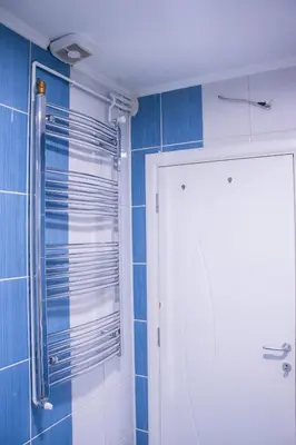 a bathroom with a shower and a white door at Apartmani Vrla in Vladičin Han