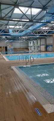 a large swimming pool in a large building at Apartman Luxor in Jagodina