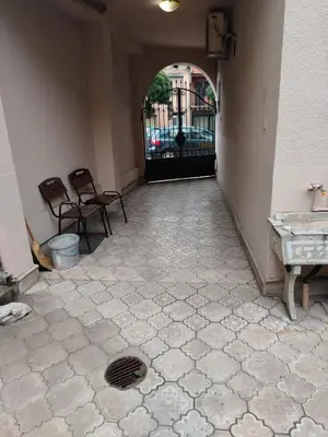 a hallway with a gate with chairs and a floor at Prenoćiste Živković in Pirot