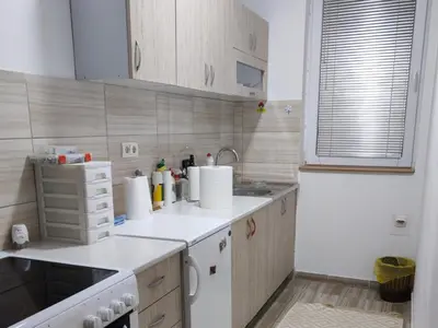 a small kitchen with white cabinets and a sink at BakaBaka in Pojate