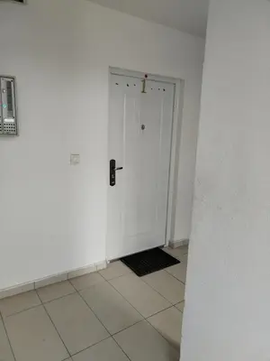 a hallway with a white door and a tile floor at BakaBaka in Pojate