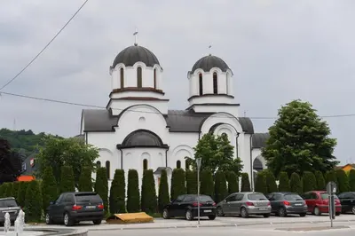 a church with cars parked in front of it at Dobi Apartmani WING 7 in Jagodina