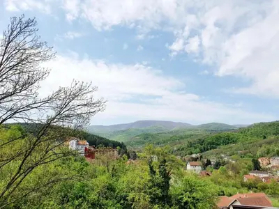 a view of a town with mountains in the distance at Perla Lux in Vrnjačka Banja