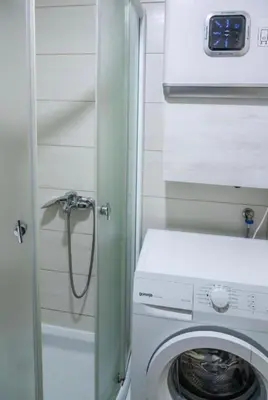 a washer and dryer in a small room at Perla Lux in Vrnjačka Banja