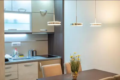 a kitchen with a table and a sink at Perla Lux in Vrnjačka Banja