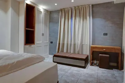 a bedroom with a bed and a bench and a desk at Vlasinsko jezero VILA BEST in Surdulica