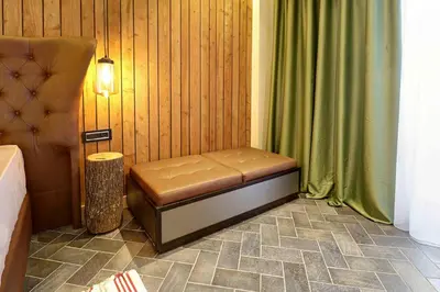 a bench sitting in a corner of a room at Vlasinsko jezero VILA BEST in Surdulica