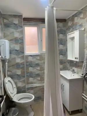 a bathroom with a toilet and a sink at City Dream in Soko Banja