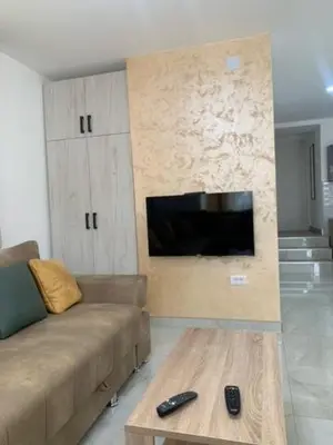 a living room with a couch and a coffee table at City Dream in Soko Banja