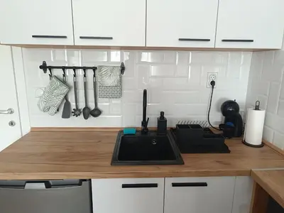 a kitchen with white cabinets and a counter top at Apartment Eight - Pirot in Pirot