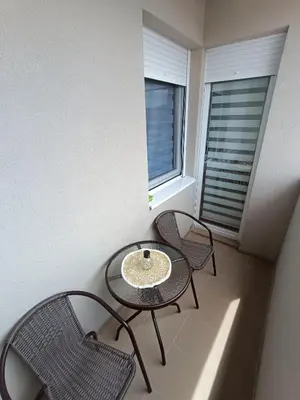 a table and chairs in a room with a window at Apartment Eight - Pirot in Pirot