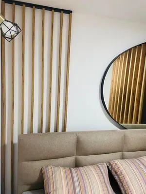 a living room with a couch and a mirror at Urban Chic Studio in Niš
