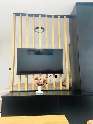a flat screen tv sitting on top of a table at Urban Chic Studio in Niš