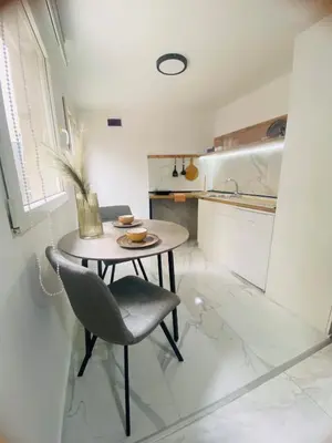 a small table and a chair in a kitchen at Urban Chic Studio in Niš