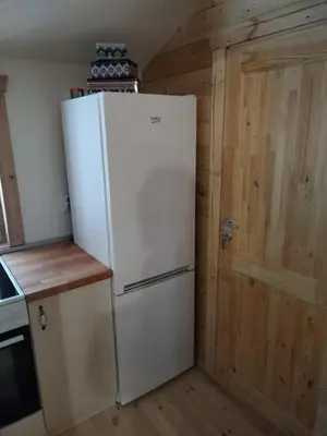 a white refrigerator in a kitchen next to a door at Milica 1 Mezdrejska 87 in Kalna