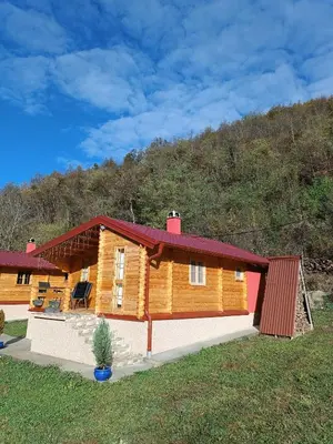 a log cabin with a red roof at Milica 1 Mezdrejska 87 in Kalna