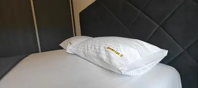 a white pillow sitting on top of a bed at Kovan Lux 9 Sokobanja in Soko Banja