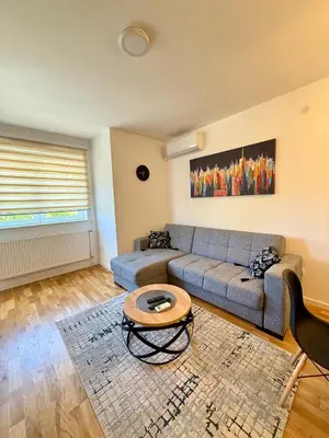 a living room with a couch and a table at Kovan Lux 9 Sokobanja in Soko Banja
