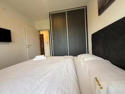 a bedroom with two beds and a closet at Kovan Lux 9 Sokobanja in Soko Banja