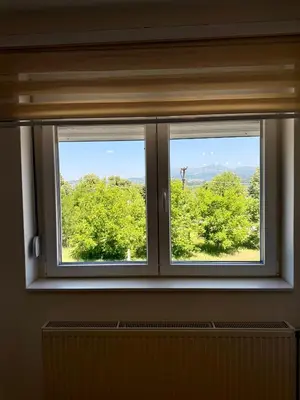 a window in a room with a view of trees at Kovan Lux 9 Sokobanja in Soko Banja