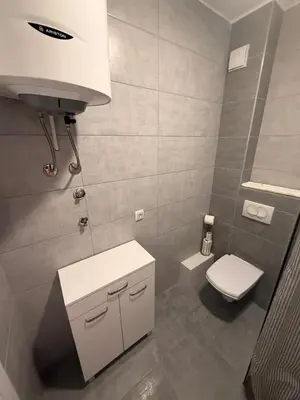 a bathroom with a white toilet and a sink at Kovan Lux 11 Sokobanja in Soko Banja