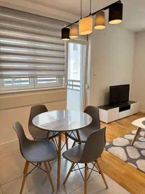 a dining room with a glass table and chairs at Kovan Lux 11 Sokobanja in Soko Banja