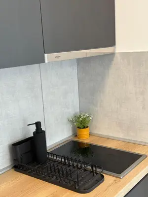 a kitchen counter with a black stove top oven at Kovan Lux 11 Sokobanja in Soko Banja