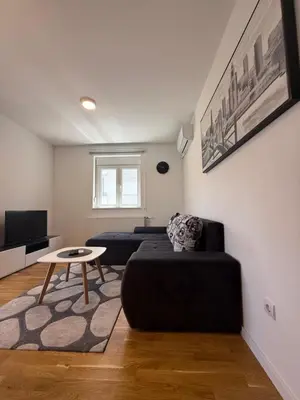 a living room with a couch and a table at Kovan Lux 11 Sokobanja in Soko Banja