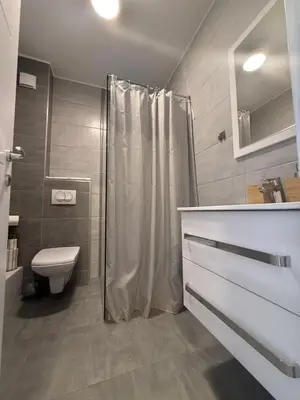 a bathroom with a shower and a toilet and a sink at Kovan Lux 11 Sokobanja in Soko Banja