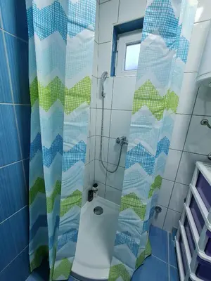 a bathroom with a shower with a shower curtain at Apartment Čolović in Raška