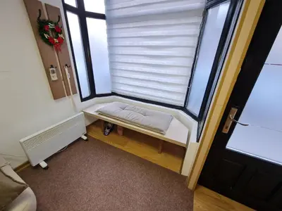 a small room with a window with a white blind at Apartment Čolović in Raška